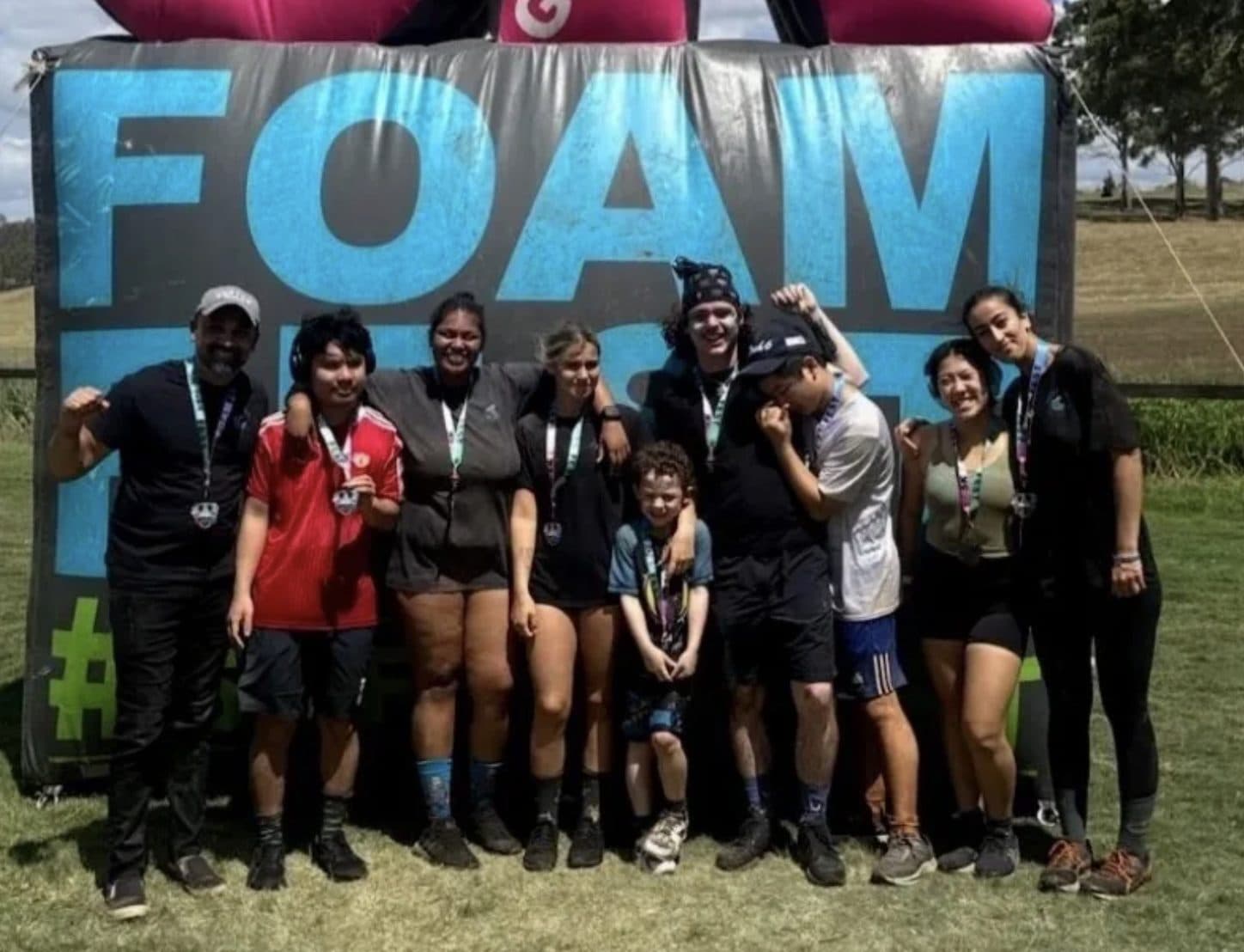 The group celebrating with medals at Foam Fest