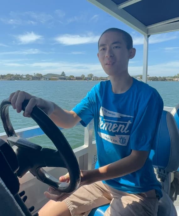 A participant steering a boat on the water