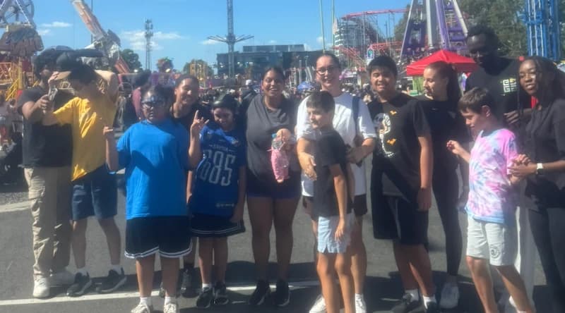 A large group day out together at a theme park